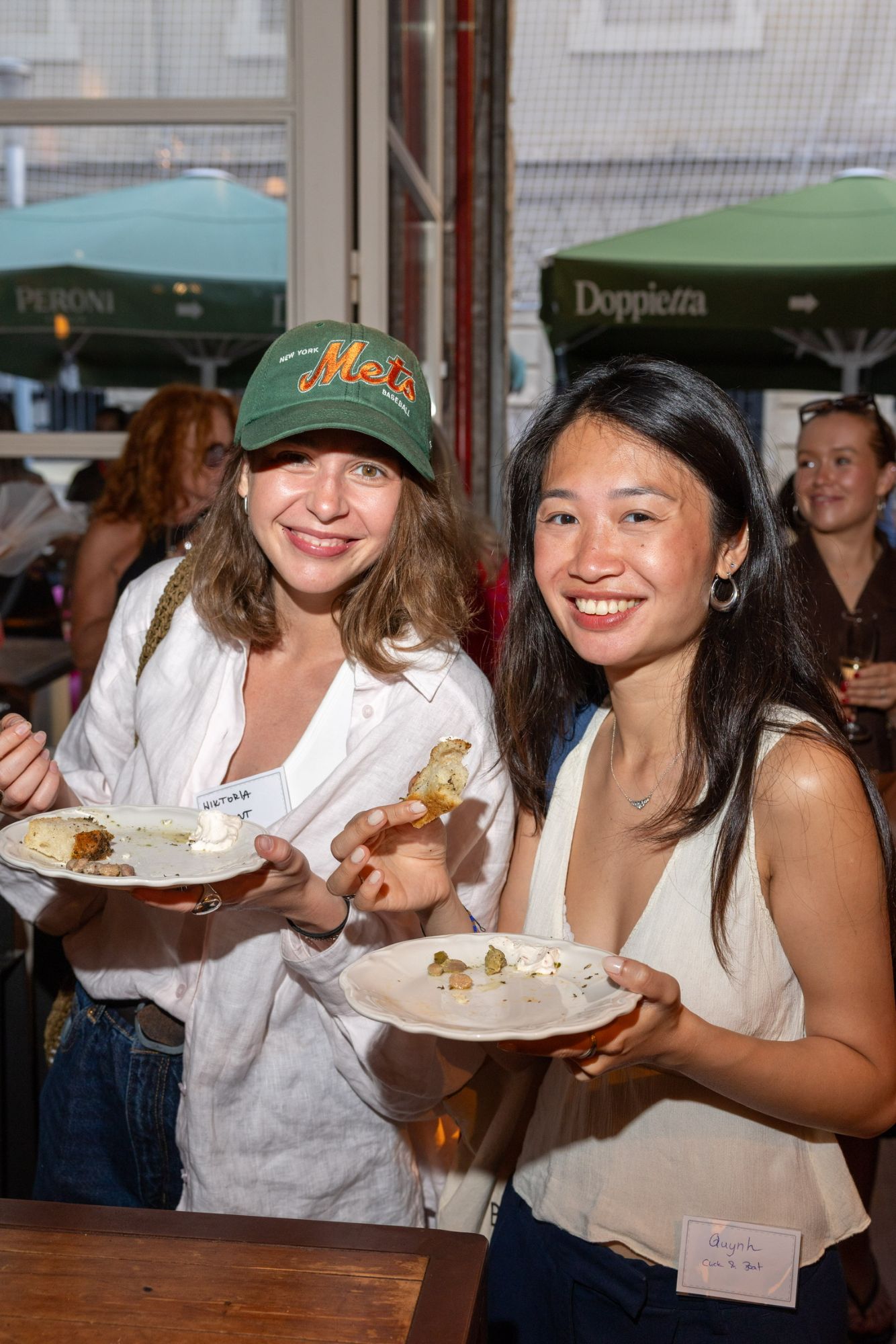Two guests with plates from the grazing table on the terrace