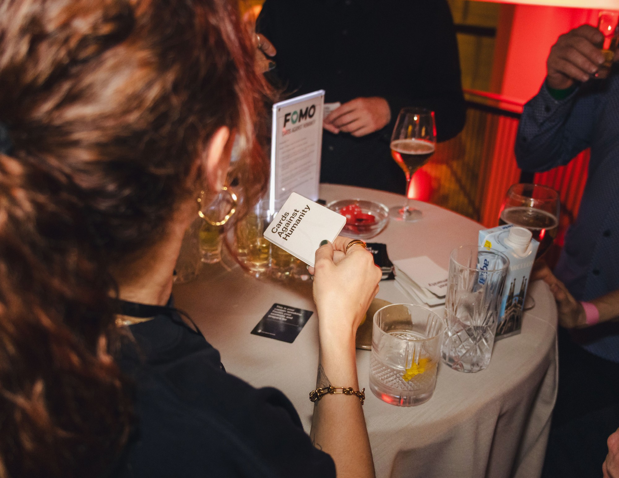 A branded card game set out on a cocktail table