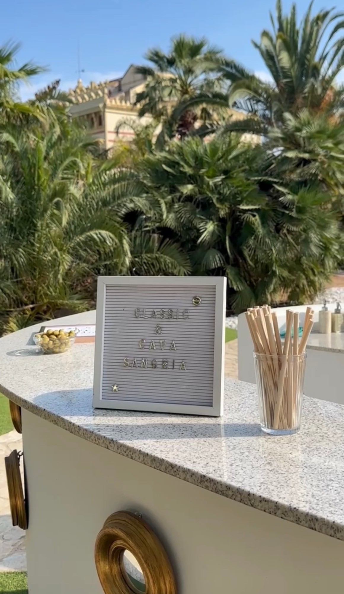 A letterboard reading Classic and Cava Sangria on the garden bar
