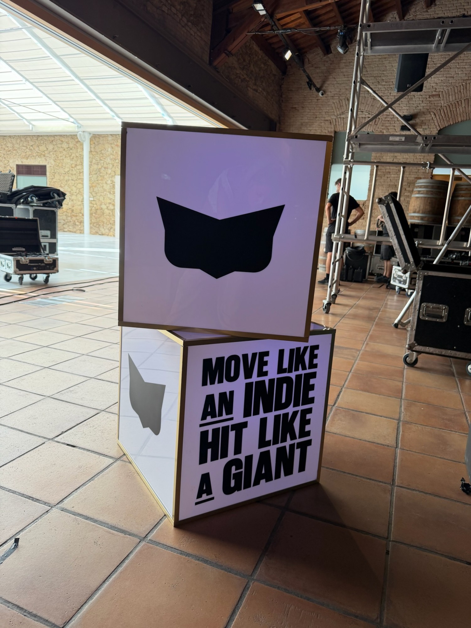 Illuminated cubes carrying the brand mark and slogans in the indoor party space